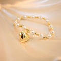 Pulsera perlas doradas y blancas